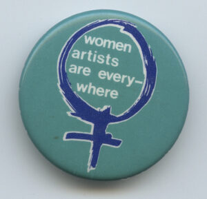 A button drawing attention to women artists.